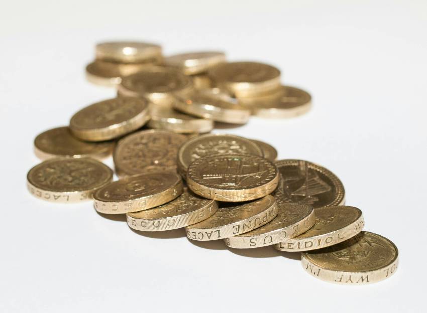 many pound coins on a white background