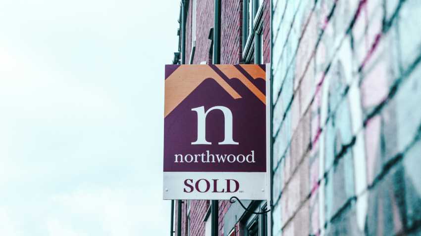 "Sold" sign on house